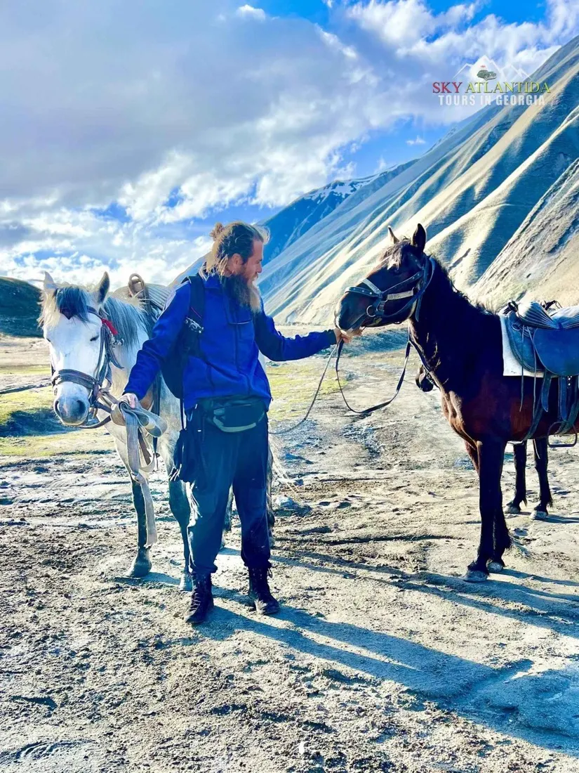 Guide with horses in the mountains near Kazbegi