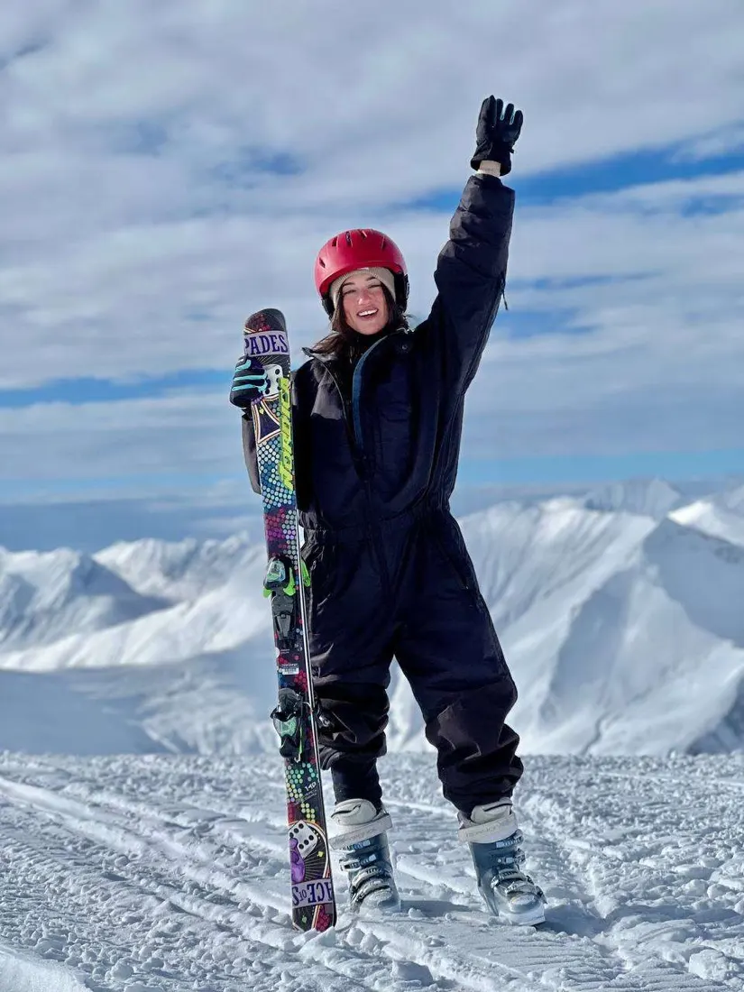 Skier celebrating on a sunny Gudauri slope
