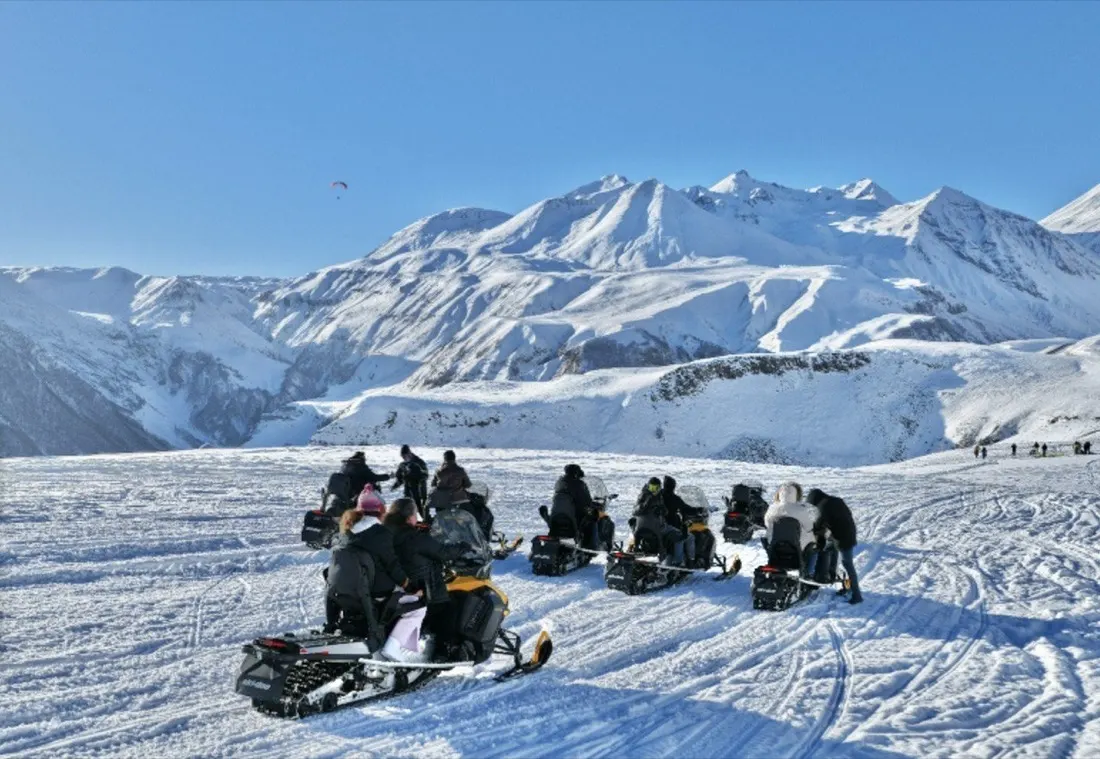Snowmobile group ride above Gudauri